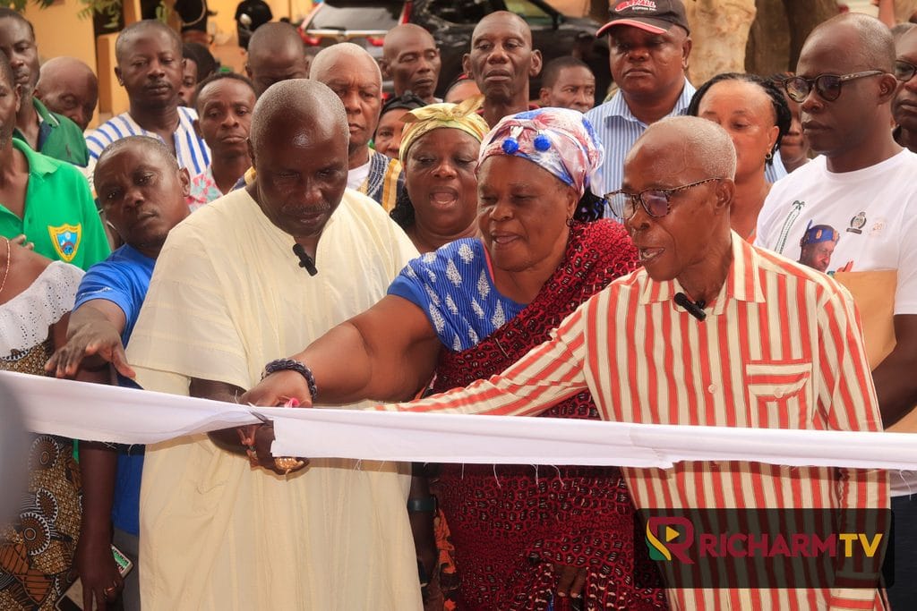 Community members cut a ribbon during the commissioning of a public toilet facility in Manya Jorpanya.