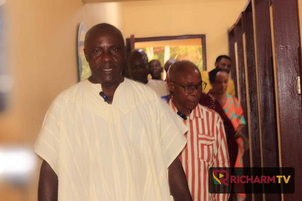 A man walks through the newly commissioned facility as community members look on.