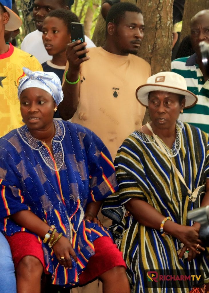 Two women in traditional dress seated outdoors during the Ngmayem celebrations.