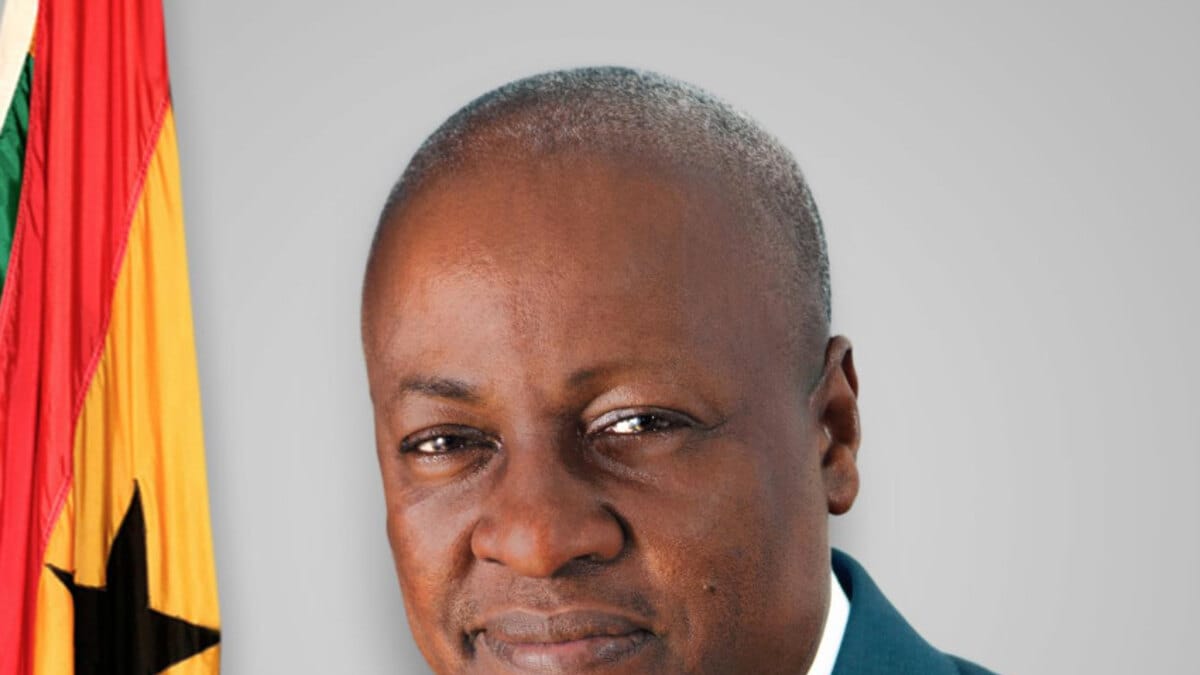 President John Dramani Mahama in an official portrait beside the Ghana flag